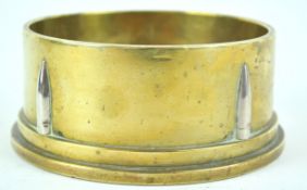 A 1942 trench art ashtray, constructed from the base of a shell case with bullet head decoration,