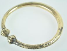 An Eastern brass anklet or Kara with ornamentation,