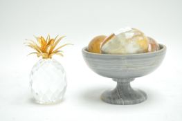 A turned agate bowl with stone eggs and a Swarovski pineapple