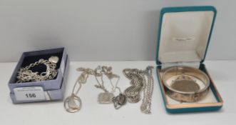 A collection of assorted silver necklaces,