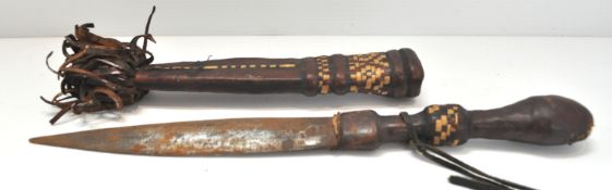 An early 20th century Sudanese dagger having leather and grass decorated hilt and scabbard,