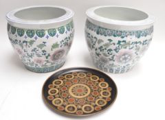 A matched pair of Chinese style large plant pots with floral repeating design,