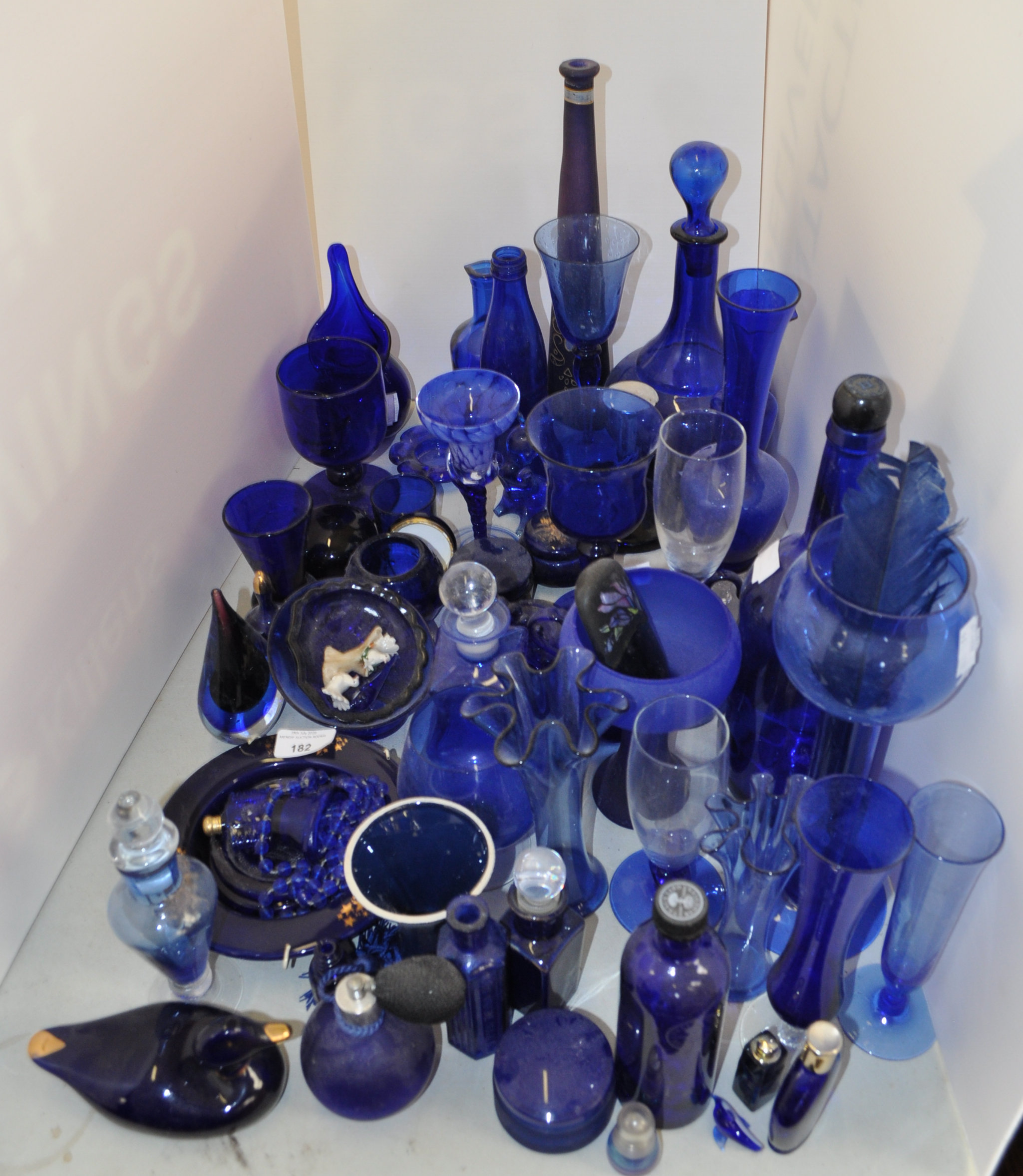 A group of assorted blue glassware