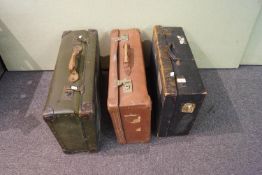 A set of three vintage suitcases and a shoulder satchel