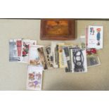 A group of assorted postcards in a wood box