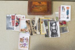 A group of assorted postcards in a wood box