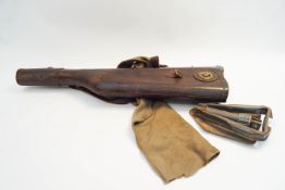 A leather gun case and a folding spade