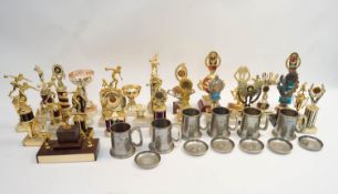 A large collection of assorted trophies and pewter mugs