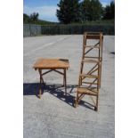 A folding garden table and a wooden step ladder