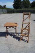 A folding garden table and a wooden step ladder
