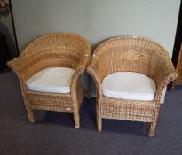 A pair of cane tub shaped chairs,