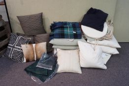 A quantity of cushions and linen