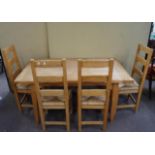 A pine dining table and chairs for four,