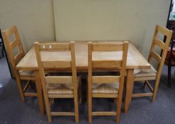 A pine dining table and chairs for four,
