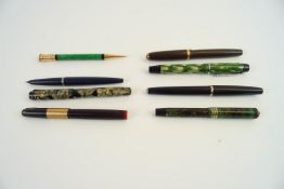 A group of fountain pens and others