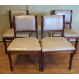 A set of four dining chairs with leatherette seats and backs