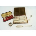 A silver spoon and pusher and other items