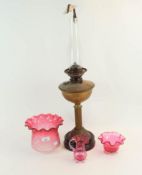 A Victorian oil lamp and two pieces of cranberry glass