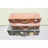 A leather suitcase and two others