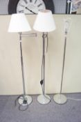 A pair of chrome standard lamps and another