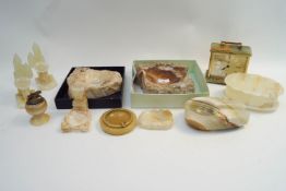 A collection of onyx and other stone items to include a pipe rest