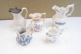 A collection of five 19th century jugs and ewers, having sprigged decoration,