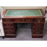 A mahogany pedestal desk with leather inset top