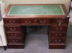 A mahogany pedestal desk with leather inset top
