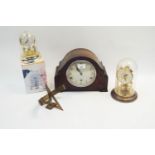 A wooden mantle clock with two others and a brass sundial