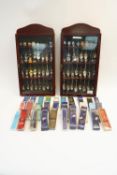 Two wall cases containing 48 Collector's spoons, boxed,