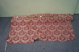 A bolt of Damask style cloth and a counter ruler