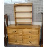 An oak chest of drawers and a set of hanging shelves,