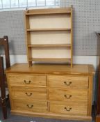An oak chest of drawers and a set of hanging shelves,