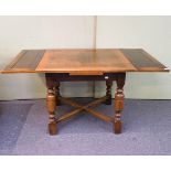 An oak draw leaf table on turned legs,