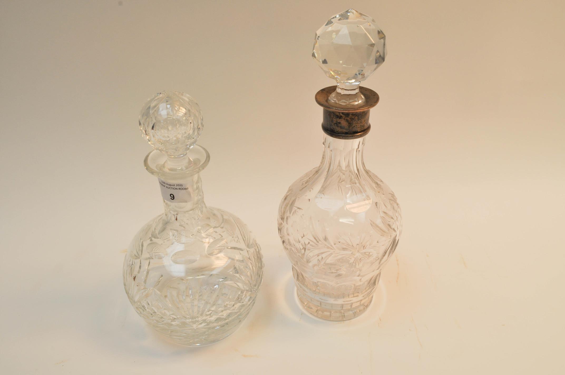 A silver collared cut glass decanter and another