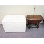 An oak drop leaf table and an ottoman