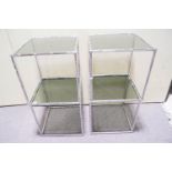 A set of four chrome and glass topped occasional tables,