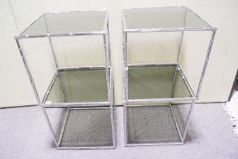 A set of four chrome and glass topped occasional tables,