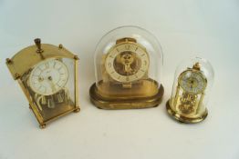 Two domed clocks and another