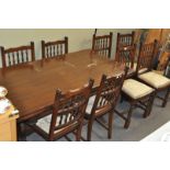 An oak draw leaf refectory table and eight chairs