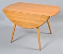 An Ercol ash drop leaf table, of oval form, on splayed legs,
