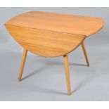 An Ercol ash drop leaf table, of oval form, on splayed legs,