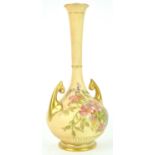 A Royal Worcester blush ivory baluster two handled vase, decorated with a floral spray,