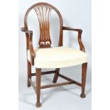 A George III style mahogany elbow chair with pierced splat, stuff over seat,