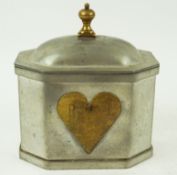 A Dutch Arts and Crafts pewter tea caddy, with brass heart detail, 15.