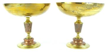 A pair of Islamic embossed copper and brass bowls on urn shaped stem with flared foot, 16.