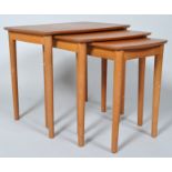 A nest of three 1970's tables on turned tapering legs, 47.5cm high x 43.5cm wide x 40.