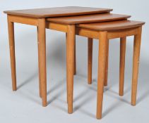A nest of three 1970's tables on turned tapering legs, 47.5cm high x 43.5cm wide x 40.