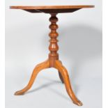 A mahogany occasional table on 19th century turned pedestal, on cabriole legs,