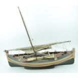 A painted ship's model of a fishing boat with lateen sail,